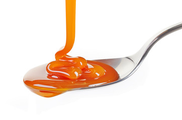 spoon of caramel sauce