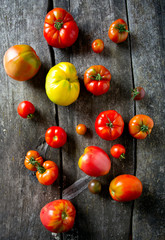 assorted tomatoes on wooden surface