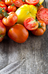 assorted tomatoes on wooden surface
