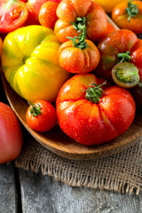 assorted tomatoes on wooden surface