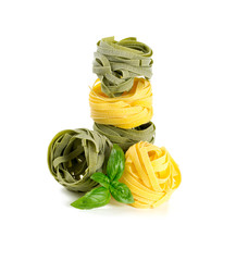 italian pasta tagliatelle with basil isolated on white