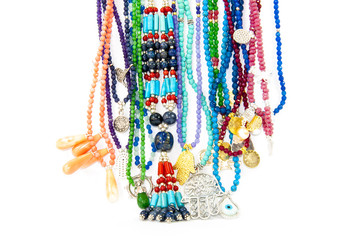 Close-up on very colourful handmade necklaces isolated by white background