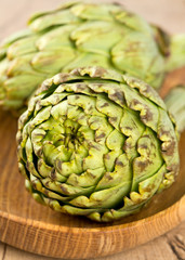 Fototapeta premium artichokes on wooden surface