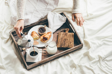 Woman having breakfast in bed. Window light - obrazy, fototapety, plakaty