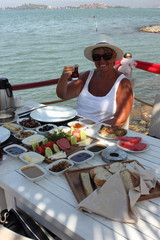 An english lady having a turkish breakfast along the port of fethiye in turkey, 2015 