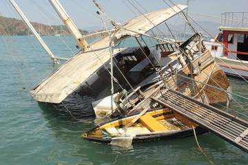 Fototapeta na wymiar A sunken boat along the port of fethiye in turkey 2015