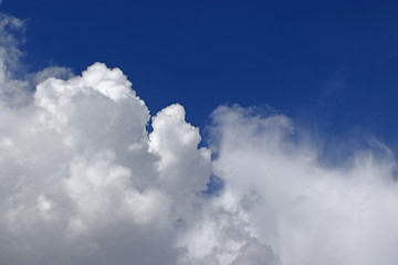 Cumulus thunderstorm clouds against blue skies