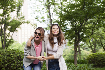 Two young women who are happily walk