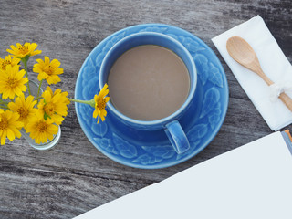 cup of coffee and notepad on wood table