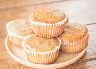 Homemade banana muffins on wooden plate