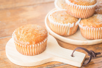 Homemade banana muffins on wooden plate
