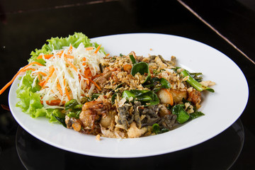 Fried frog legs with olive, herbs and spices