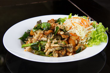 Fried frog legs with olive, herbs and spices