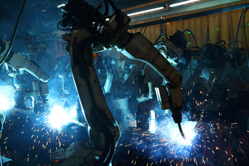 group welding robots are working In the automotive parts industry.