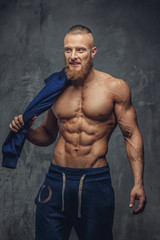 Fototapeta na wymiar Portrait of muscular shirtless man with beard.