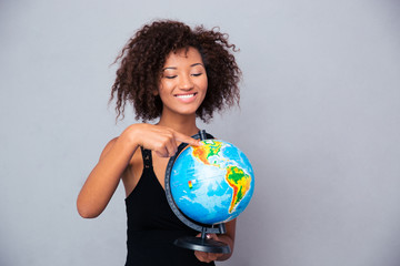 Afro american woman holding globe