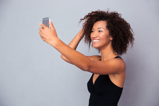Smiling afro american woman making selfie photo
