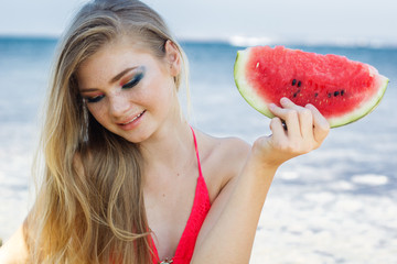 Beauty teenage model girl eating watermelon. 