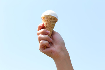 Woman hand holding waffle with ice cream