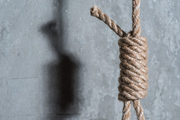 Hangman's loop over the grey concrete wall