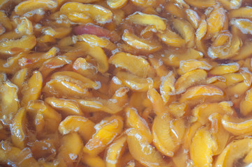 Making apricot jam. Apricot slices cooking before conservation