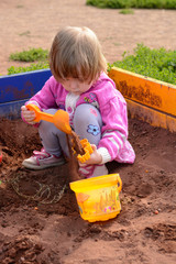 Girl playing in the sand