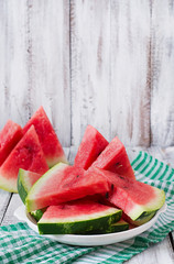 Slices of juicy and tasty watermelon on a white plate