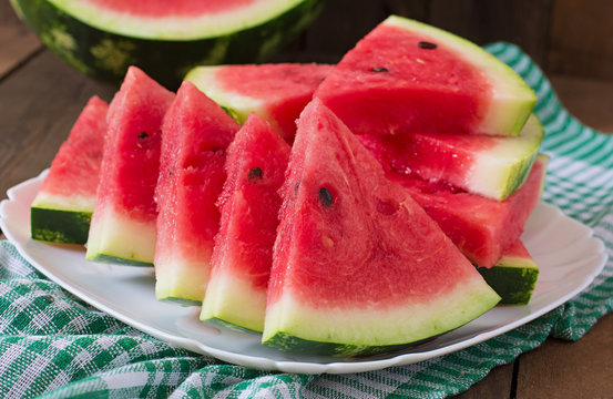 Slices of juicy and tasty watermelon on a white plate