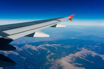 Fototapeta premium Plane above mountains