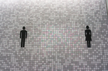 Toilet sign on mosaic wall