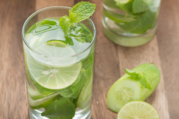 Detox water, lime with cucumbers and mint in glass. Downward vie