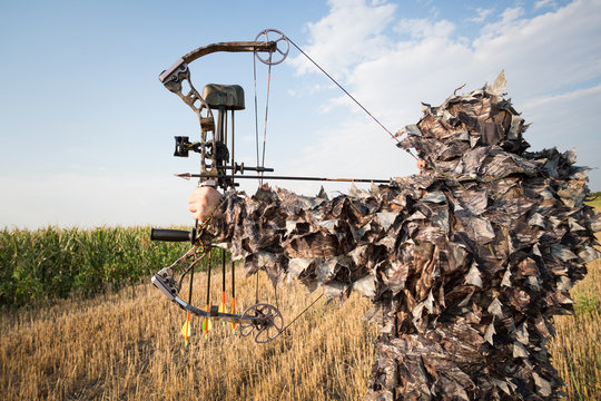 Hunter in camouflage with his bow 