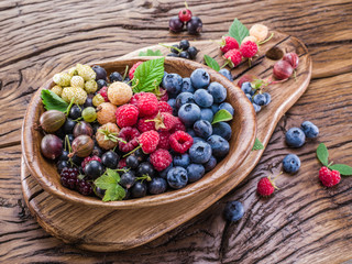 Ripe berries in the wooden bowl.