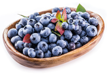 Ripe berries in the wooden bowl.