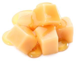 Sweet caramel candies on the white background.