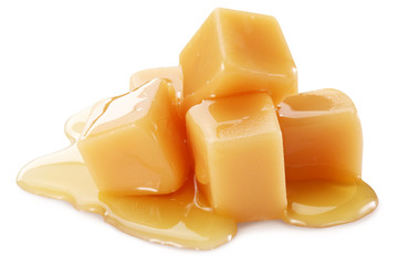 Sweet caramel candies on the white background.