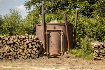 Old tanks for burning charcoal from tree.