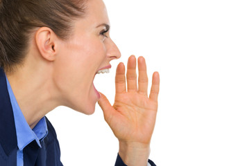 Closeup of businesswoman shouting and cupping hand to mouth