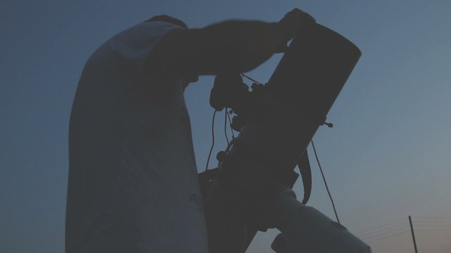 Stargazing with a telescope.