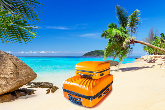 Summer holidays with baggages on the tropical beach