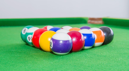 Snooker balls on green table.