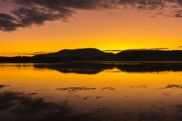Fototapeta na wymiar Beautifully rich coloured sunrise at Lake Moogerah in Queensland, Australia