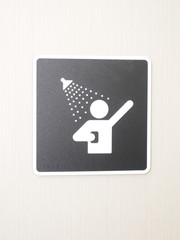 Plastic brown and white shower sign on a cubicle, Melbourne 2016