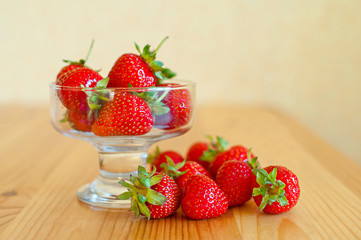 Ripe red strawberries on wooden table