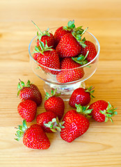 Ripe red strawberries on wooden table