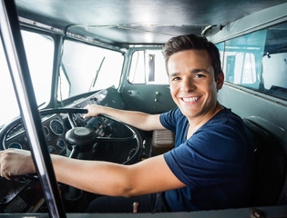 Fototapeta premium Happy Fireman Driving Firetruck