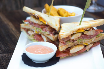 Club sandwich on toasted, served with crispy golden potato French fries