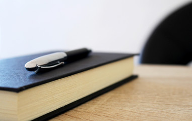 Pen with paper notepad on the table