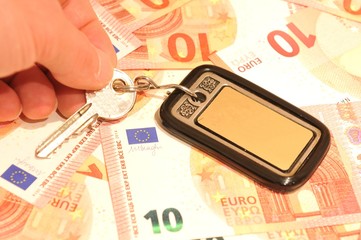 Hand and keys against euro background 