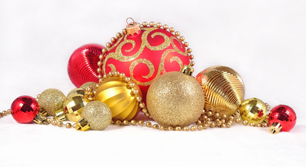 Golden and red Christmas decorations on a white
